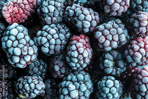 Ripe frozen blackberries as background. Fruit pattern. Top view.