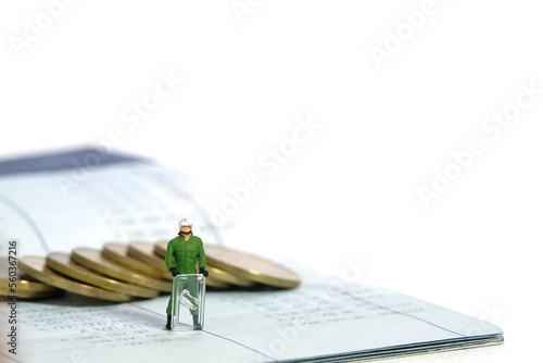Miniature people toy figure photography. Bank account protection concept. A military anti riot armored army standing above bank account with coin. Isolated on white background photo