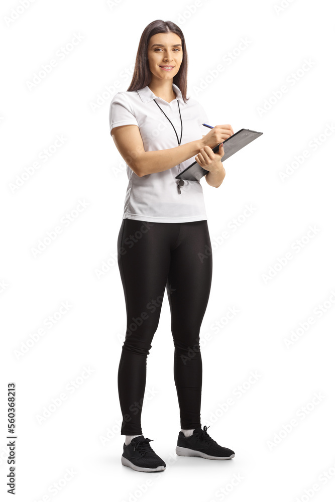 Full length portrait of a female sport coach holding a clipboard and smiling at camera Full length portrait of a female sport coach holding a clipboard and smiling at camera