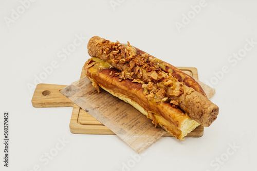 Frikandel  al pan de mollete y cebolla frita photo