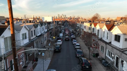 Housing in USA urban American city. Aerial above traffic jam on street in winter during golden hour.