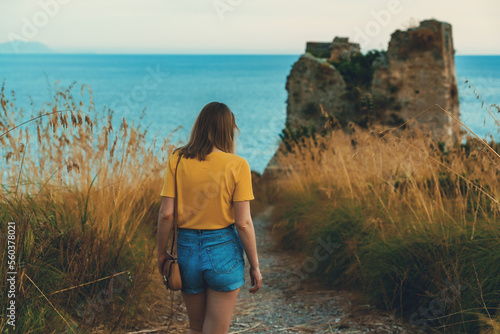 Tourist goes to Torre di Monte D'Oro in Scauri, Italy.