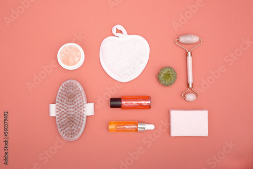 Flat lay of cosmetic products on a red background. The concept of face and body care. View from above.