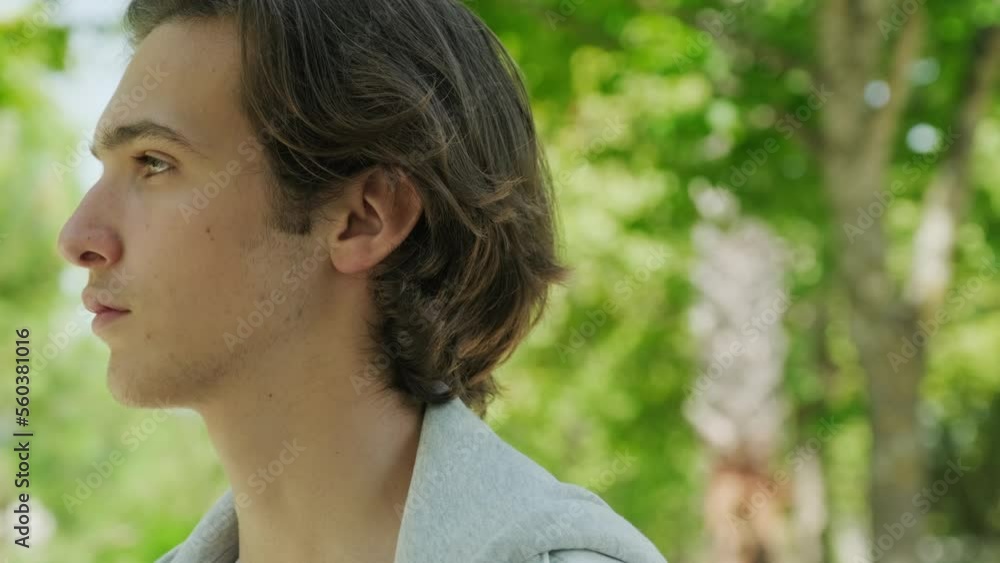 Profile, calm face of young man, outdoors. Confident look. Young sad man looks in the camera. Closeup face of handsome guy with sad eyes, in the nature. Close up frustrated teenager face, outside. Profile, calm face of young man, outdoors. Confident look. Young sad man looks in the camera. Closeup face of handsome guy with sad eyes, in the nature. Close up frustrated teenager face, outside.