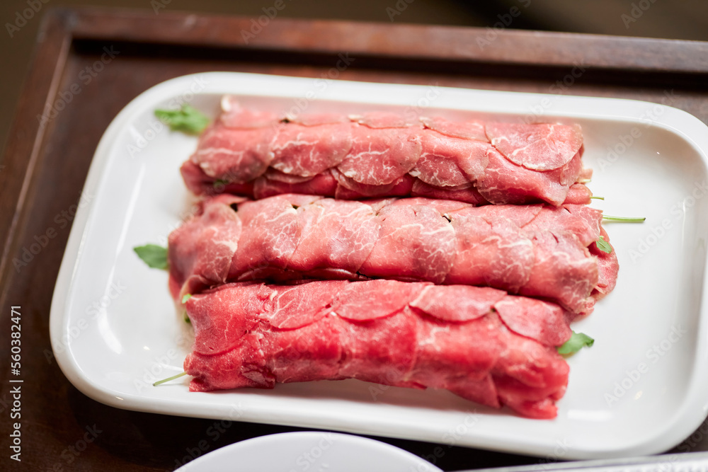 Serving carpaccio. The chef burns the carpaccio with a burner. Carpaccio. Meat in the restaurant serving dishes Serving carpaccio. The chef burns the carpaccio with a burner. Carpaccio. Meat in the restaurant serving dishes