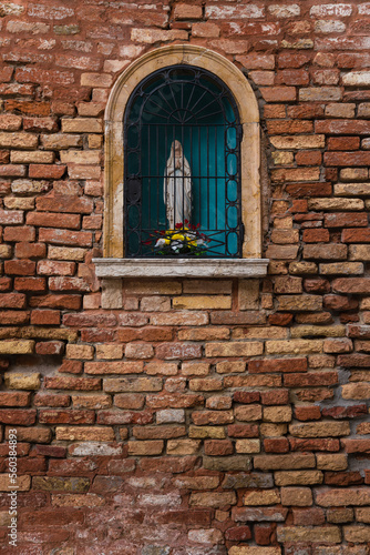 shrine of the Virgin Mary in an old brick wall. 