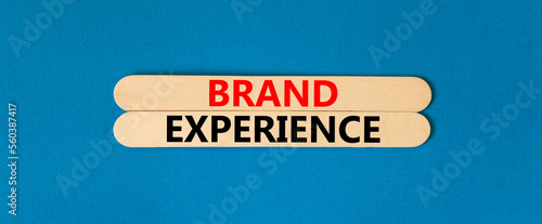 Brand experience symbol. Concept words Brand experience on wooden stick. Beautiful blue table blue background. Business branding and brand experience concept. Copy space.