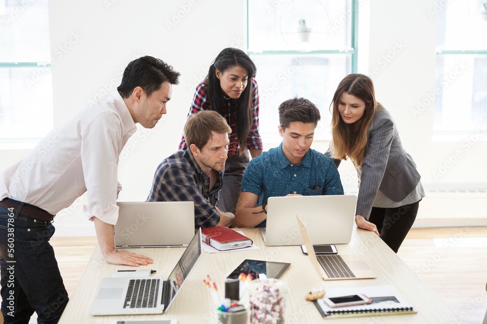 Creative business people using laptop in board room Creative business people using laptop in board room