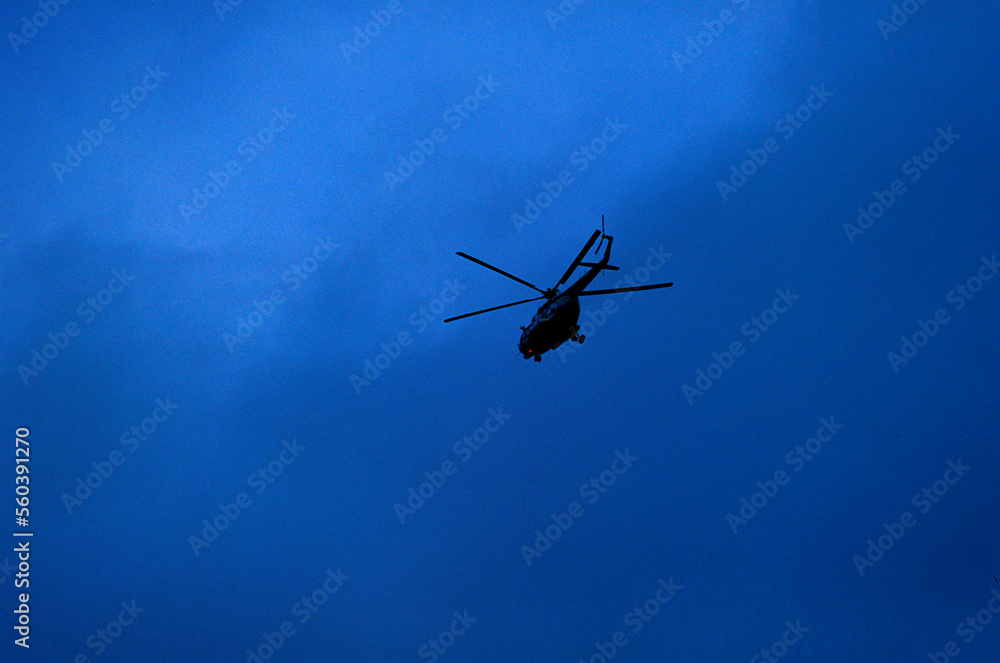 A helicopter flying in dark clouds over northern Vietnam. A helicopter flying in dark clouds over northern Vietnam.