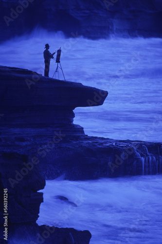 A man paints on the coast of California. photo