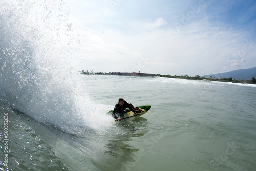 Water pespective of a waveskier dropping into a wave. photo