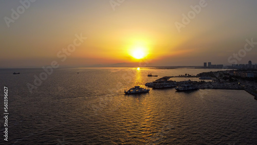 Turkey İzmir Karsiyaka Bostanli Ferry Pier sunset view aerial shot with drone, January 11, 2023.