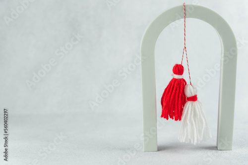Traditional Martisor - symbol of holiday 1 March, Martenitsa, Baba Marta, beginning of spring and seasons changing in Romania, Bulgaria, Moldova. Greeting and post card for holidays. photo