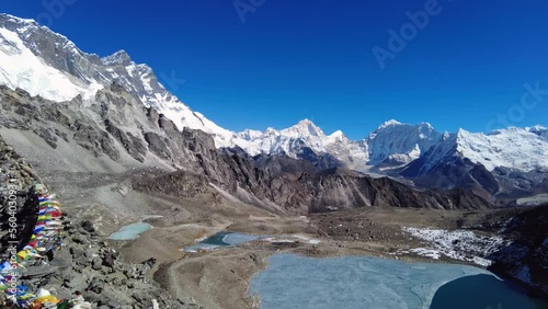Kongma La, Nepal: Panoramic view of the top of the Kongma La pass between Chukung and Lobuche culminating at 5535m toward Everest base camp in the Himalayas in Nepal with tibetan buddhism prayer flags photo