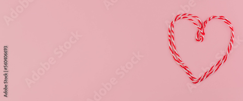 Traditional Martisor heart - symbol of holiday 1 March, Martenitsa, Baba Marta, beginning of spring and seasons changing in Romania, Bulgaria, Moldova. Greeting and post card for holidays. Pink . photo