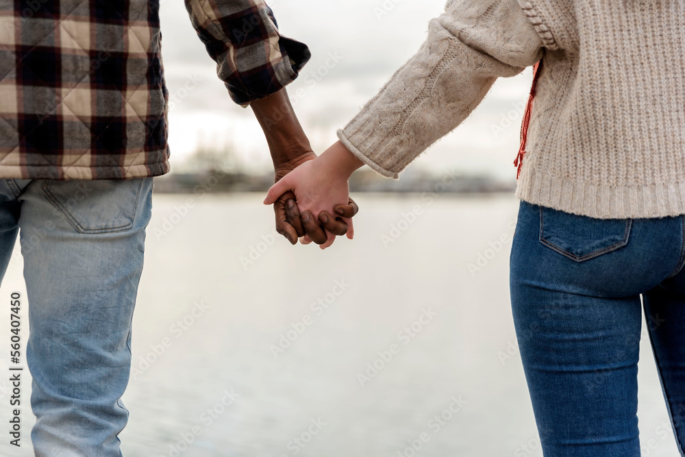 multiracial lovers couple holding hands. International love concept