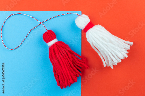 Traditional Martisor - symbol of holiday 1 March, Martenitsa, Baba Marta, beginning of spring and seasons changing in Romania, Bulgaria, Moldova. Greeting and post card for holidays. photo