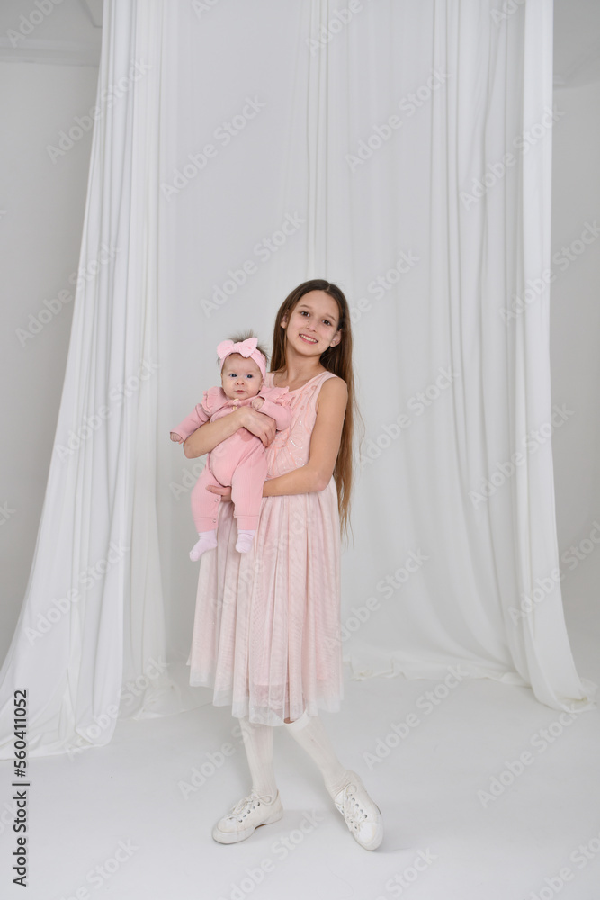 mother and daughter. Beautiful girl in a white room mother and daughter. Beautiful girl in a white room