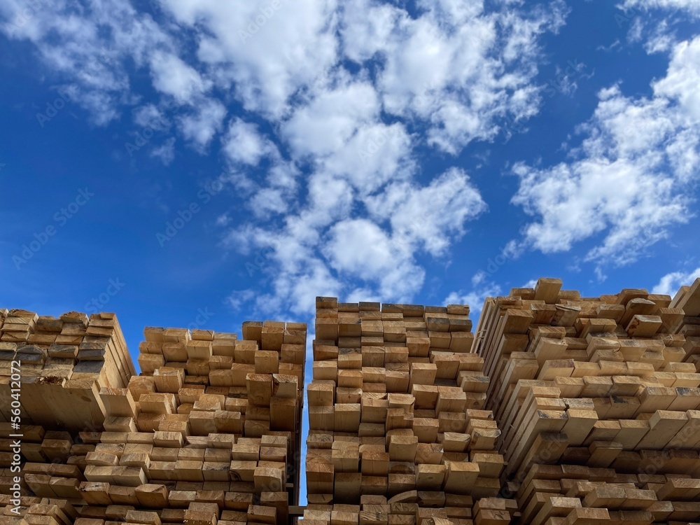 Wooden boards, lumber, industrial wood, timber. Pine wood timber stack of natural rough wooden boards on building site. Industrial timber building materials Wooden boards, lumber, industrial wood, timber. Pine wood timber stack of natural rough wooden boards on building site. Industrial timber building materials