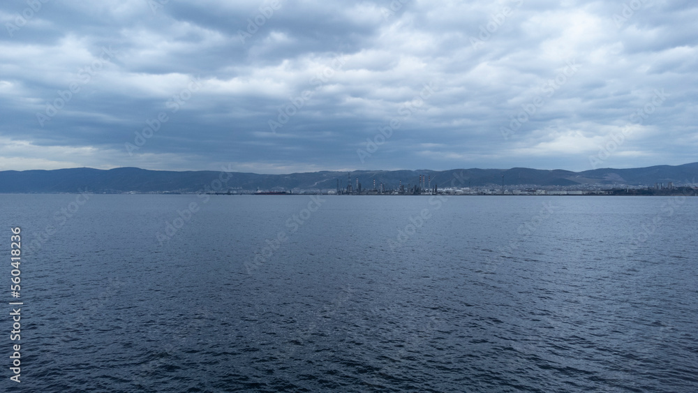 Oil refinery plant. Petrochemical factory and merchant ships in Gulf of Kocaeli Izmit Turkey. Factory causing environmental disaster with chemical gas. Noise and grain included. Selective focus