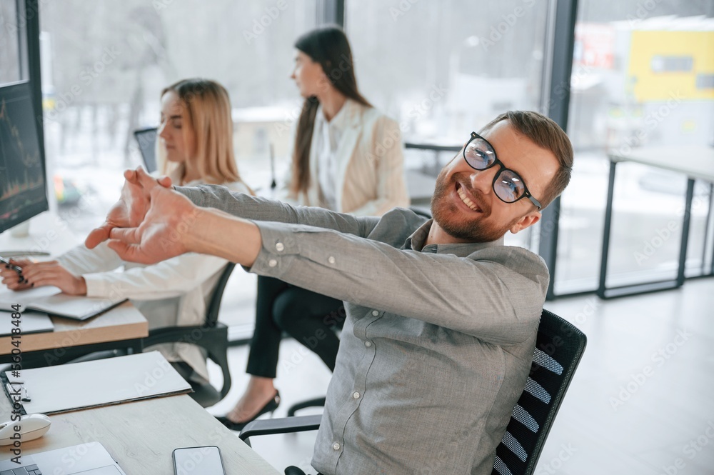 Man is satisfied about results. Successful team are working together in the office. Conception of business Man is satisfied about results. Successful team are working together in the office. Conception of business