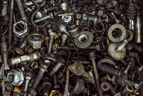 a large number of old rusty and oil-stained car parts