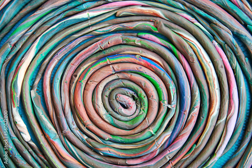 Abstract colorful plasticine spiral made by kids in the school. Toy and play backgrounds