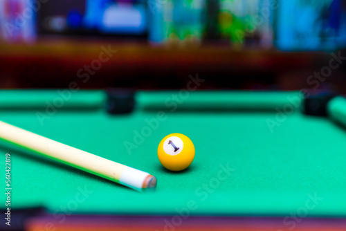 Billiard pool game one ball with cue on billiard table with green cloth.Blurred background.