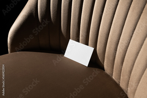 Blank business cards mockup template on a velvet, beige art deco furniture, real photo. Isolated surface to place your design. 