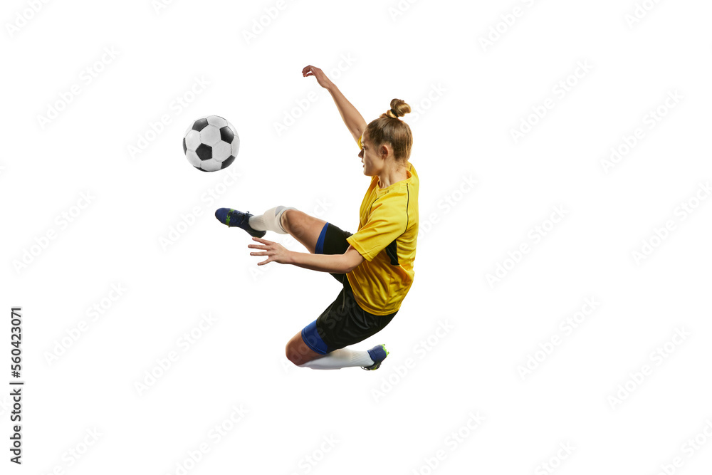 Fototapeta premium Young woman, professional female football, soccer player in motion, training, playing isolated over white background. Motivation to win