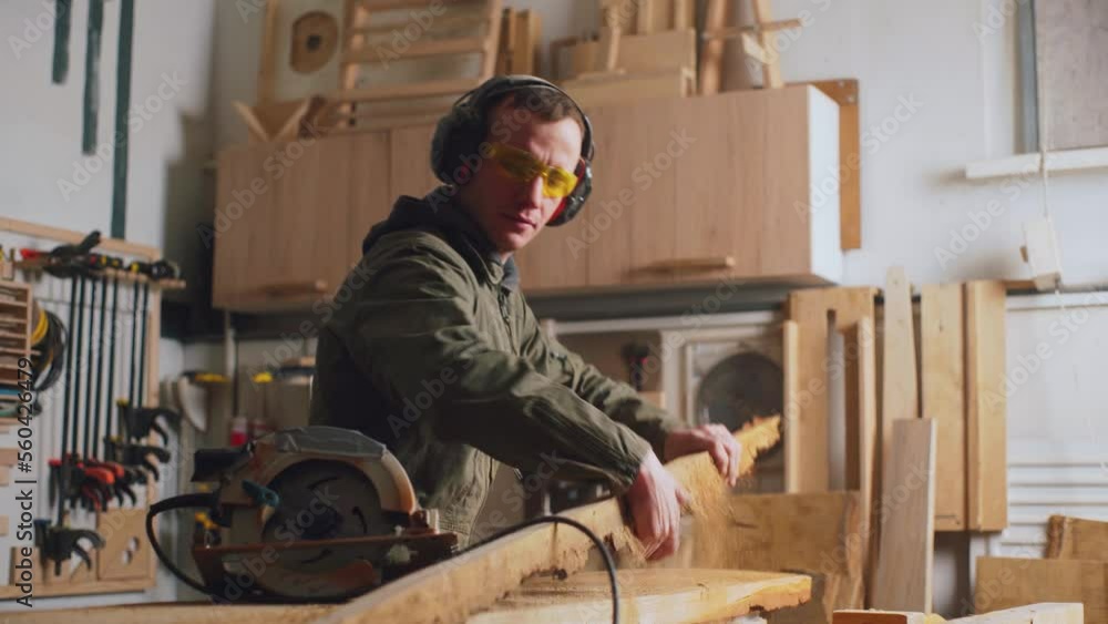 The carpenter works and shakes off the dust. Manual labor with carpentry tools. The carpenter works and shakes off the dust. Manual labor with carpentry tools.