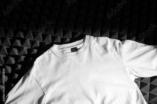 T-Shirt oversize mockup template on a black soundproof foam background with deep shadows, real photo. Blank isolated to place your design.  photo