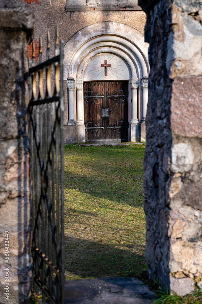 open metal gate and walkway leading to the entrance to the church, selective focus open metal gate and walkway leading to the entrance to the church, selective focus