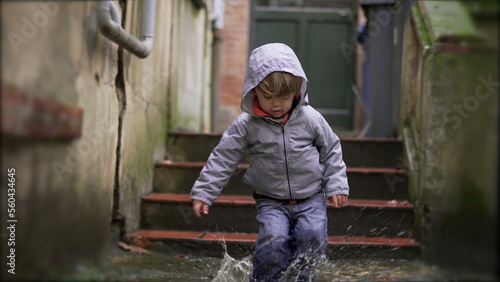 Little baby toddler jumping into water puddle5 © Marco