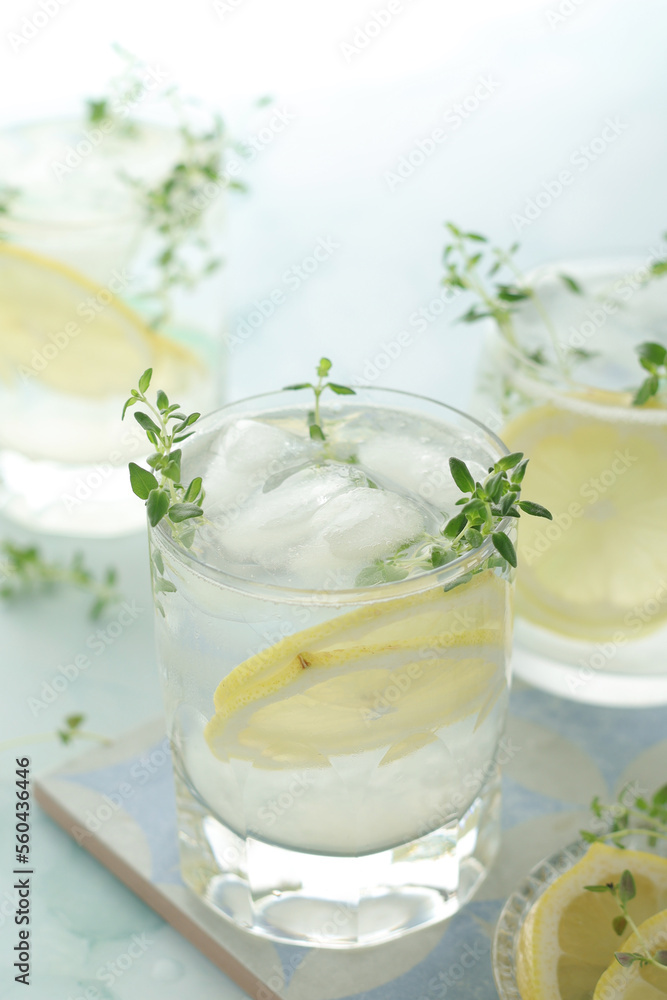 Glasses with lemon and thyme refreshing drink Glasses with lemon and thyme refreshing drink