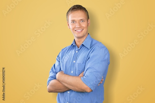 Smiling young man posing with hands crossed © BillionPhotos.com