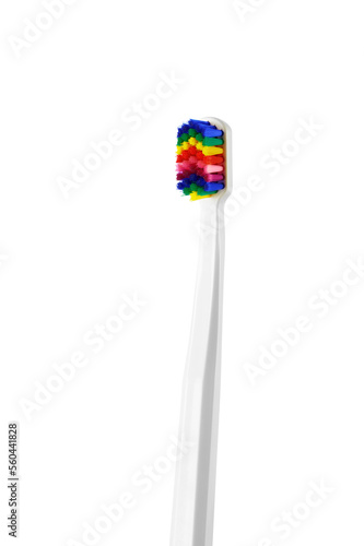 Fancy toothbrush with multicolored bristles on withe background. Bristles in all colors of the rainbow. Rainbow toothbrush with white knob. Fashionable oral care