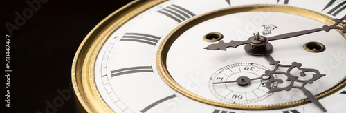 Vintage Clock with Hands.
Close up view on clock face of a historical watches with golden frame photo