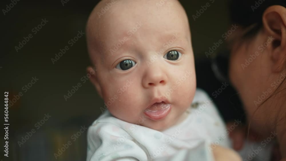 newborn baby in mothers a arms. happy family kid dream concept. mother and son baby close-up portrait indoors. cute pretty baby baby opened his mouth lifestyle newborn baby in mothers a arms. happy family kid dream concept. mother and son baby close-up portrait indoors. cute pretty baby baby opened his mouth lifestyle