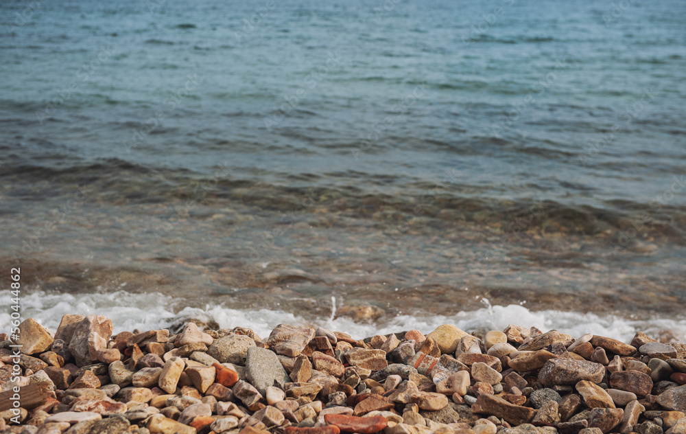 Sea background with pebbles and splash of water foam Sea background with pebbles and splash of water foam