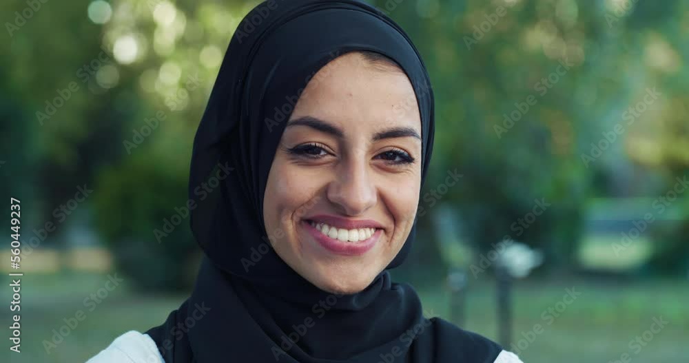 Close Up Portrait of Beautiful Young Arab Woman Looking at Camera and Smiling with a Greenery Background. Muslim Female Teenager with Hijab Enjoying Fresh Air in Park and Taking Care of her Wellbeing Close Up Portrait of Beautiful Young Arab Woman Looking at Camera and Smiling with a Greenery Background. Muslim Female Teenager with Hijab Enjoying Fresh Air in Park and Taking Care of her Wellbeing