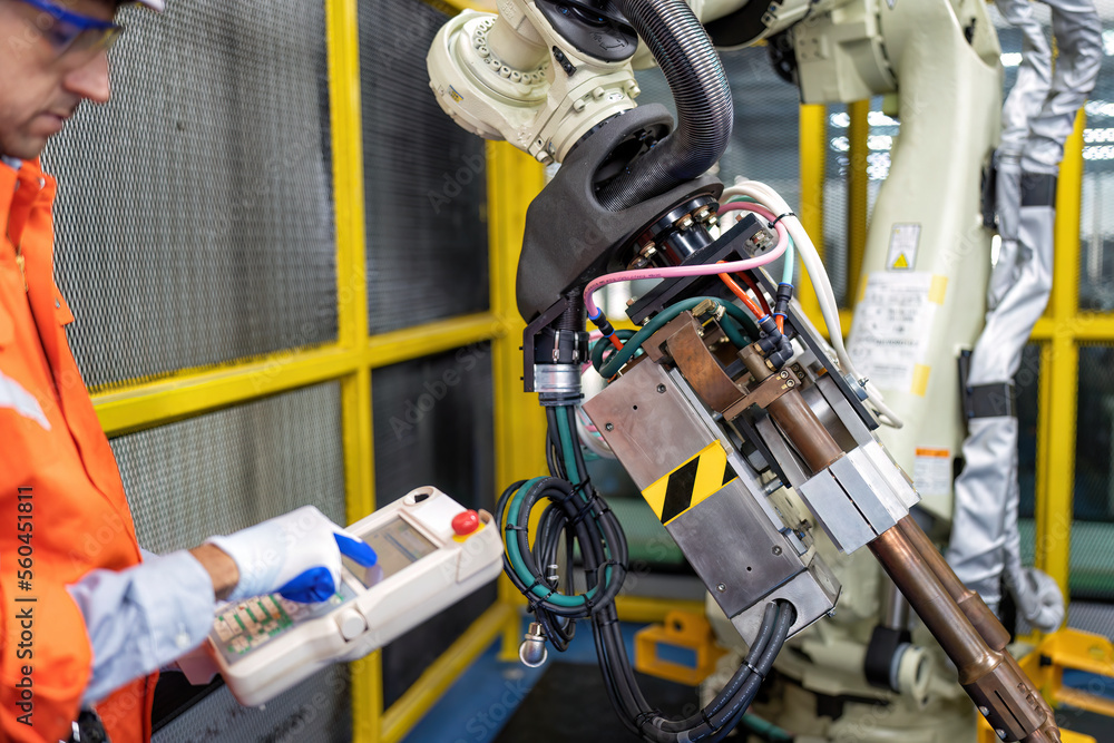 Engineer testing operation robot arm after maintenance and programing ready to send to industry Engineer testing operation robot arm after maintenance and programing ready to send to industry