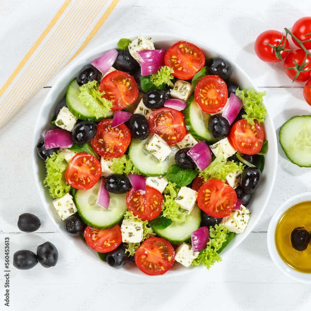 Greek salad with fresh tomatoes olives and feta cheese healthy eating food from above on a wooden board square Greek salad with fresh tomatoes olives and feta cheese healthy eating food from above on a wooden board square
