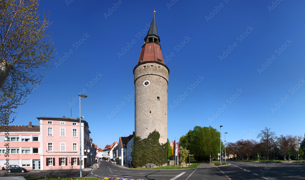 Panoramic view of a street and the medieval Falterturm tower with its leaning spire in the town of Kitzingen, Germany