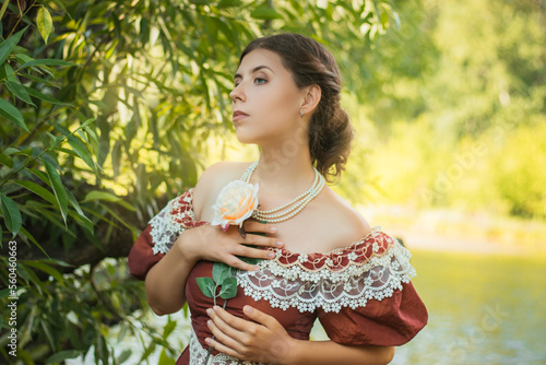 Fototapeta Portrait of a young woman in a historical dress from the 19th century