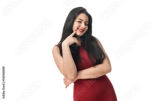 attractive woman in red dress and black hair on white background gesturing and striking poses © Paco Perpiñan