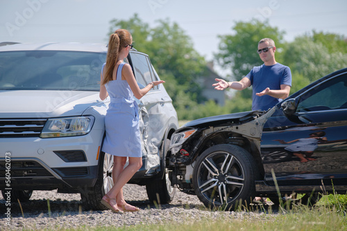 Εκτύπωση καμβά Angry woman and man drivers of heavily damaged vehicles arguing who is guilty in car crash accident on street side