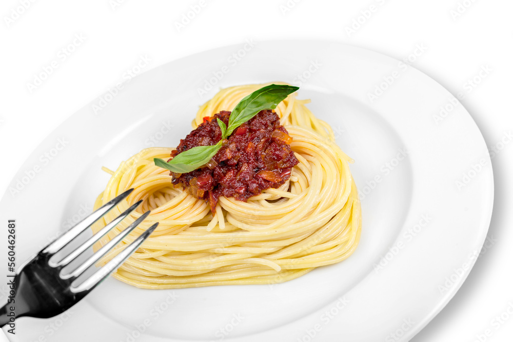 Cooked spaghetti carefully arranged in a heart shape and topped with tomato sauce accompanied by raw ingredients to the side Cooked spaghetti carefully arranged in a heart shape and topped with tomato sauce accompanied by raw ingredients to the side