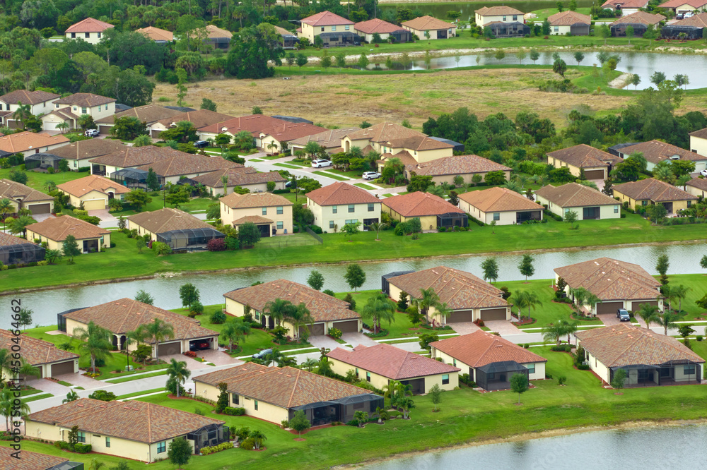 View from above of densely built residential houses in closed living clubs in south Florida. American dream homes as example of real estate development in US suburbs