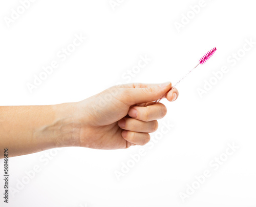 Eyelash brush in hand isolated on white background